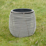 Large white woven-effect outdoor plant pot with rounded shape, displayed on grass.