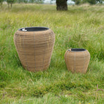 Mica Plant Pots - Light Brown Cane Pair of light brown woven-effect plant pots with curved shapes, photographed on grassy lawn. 2