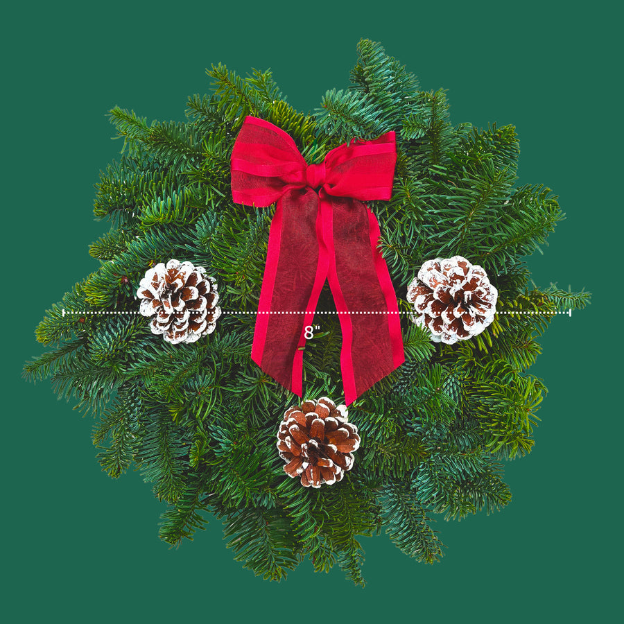 Classic Red Christmas Wreath Top-down view of an 8-inch classic red Christmas wreath with pine cones and red ribbon bow, displayed on a green background with size guide. 3
