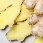 Ginger Bare Roots Close-up of sliced fresh ginger showing the pale yellow interior beside whole rhizome pieces. 4