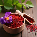 Saffron Crocus Sativus Close-up of a wooden bowl filled with vivid red saffron threads and a single purple crocus flower beside it on a wooden table, illustrating the harvested spice from Crocus sativus. 2