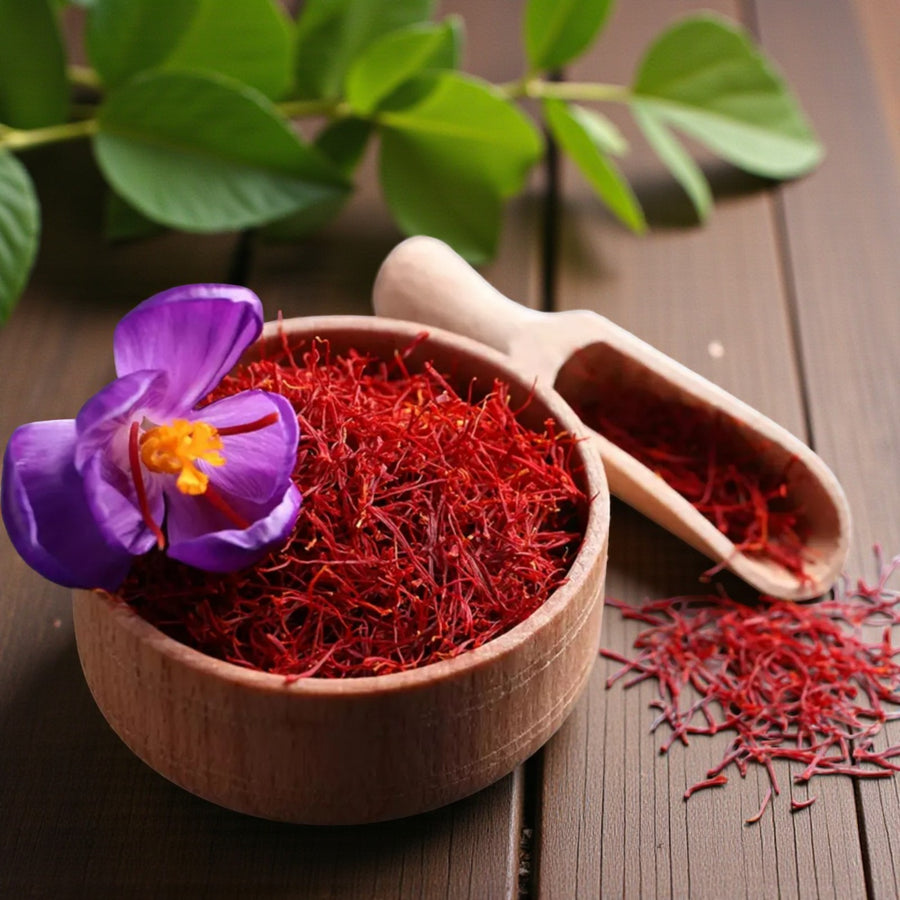 Saffron Crocus Sativus Close-up of a wooden bowl filled with vivid red saffron threads and a single purple crocus flower beside it on a wooden table, illustrating the harvested spice from Crocus sativus. 2