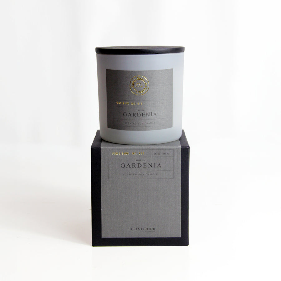 Green Gardenia Soy Candle Frosted glass candle with a grey label reading “Green Gardenia Scented Soy Candle,” displayed on its matching grey and black presentation box. Elegant and minimal design on a white background. 1