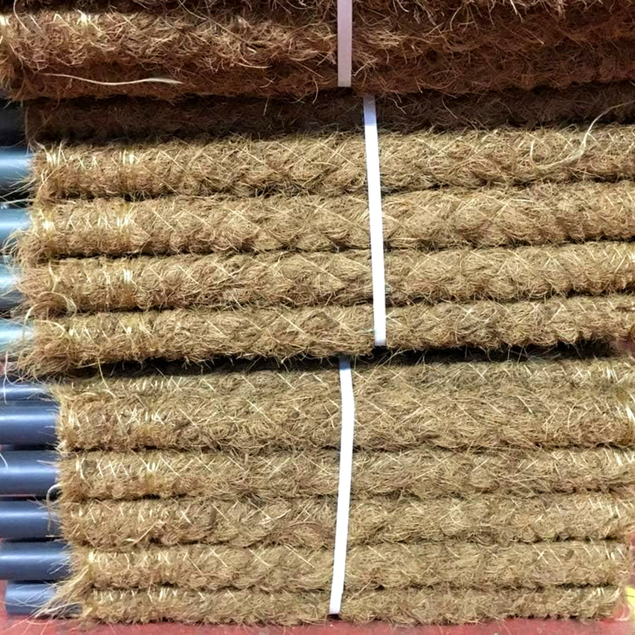Moss Pole Indoor Plant Support Stacked bundle of coir moss poles with plastic ends, tied together with white straps, displayed on a red surface. 3